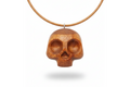 Handcrafted red oak skull pendant showing detailed carving and natural wood texture